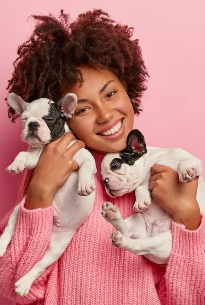 Woman holding two french bulldog puppies at the WannaDog store